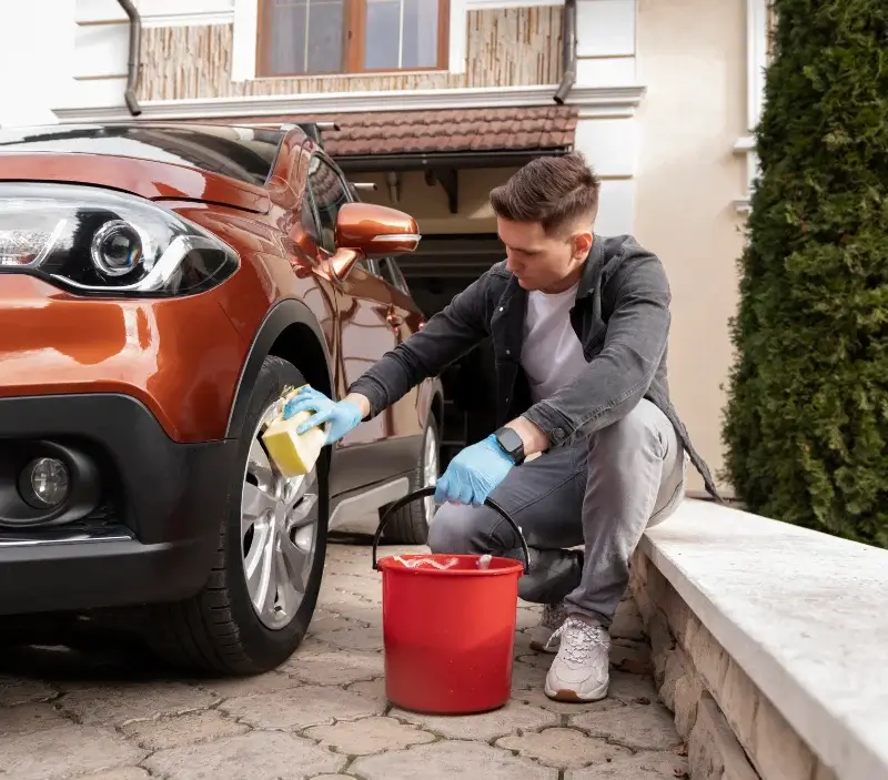 Lavage auto à domicile Pyrenees-Atlantiques : professionnel intervenant sur un véhicule
